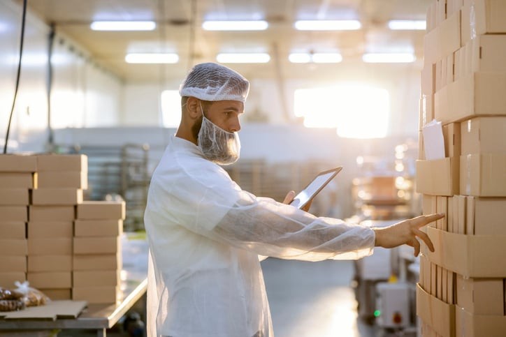 Quality manager reviewing food product inventory