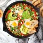 Shakshuka, eggs poached in tomato sauce with herbs and feta cheese
