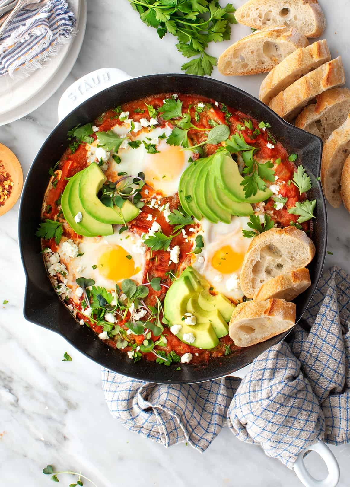Shakshuka, eggs poached in tomato sauce with herbs and feta cheese