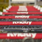 Close-up of grocery carts lined up.