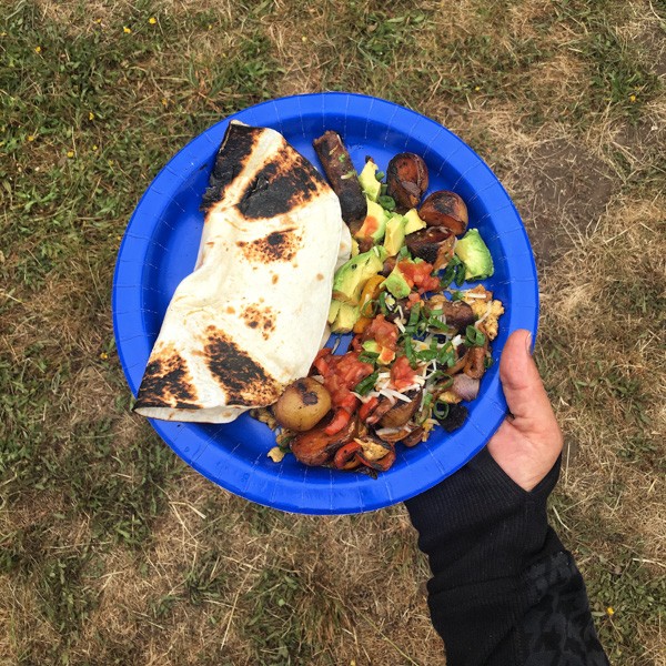 Campfire Breakfast Burritos with scrambled eggs, sausage, cheese, onions, and peppers in tortillas