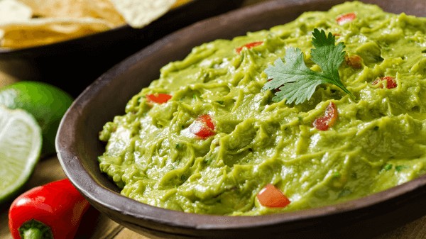 Fresh guacamole, a classic topping for tamales
