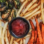 Smashburger's crispy brussels sprouts, regular fries, and sweet potato fries, showcasing rosemary seasoning