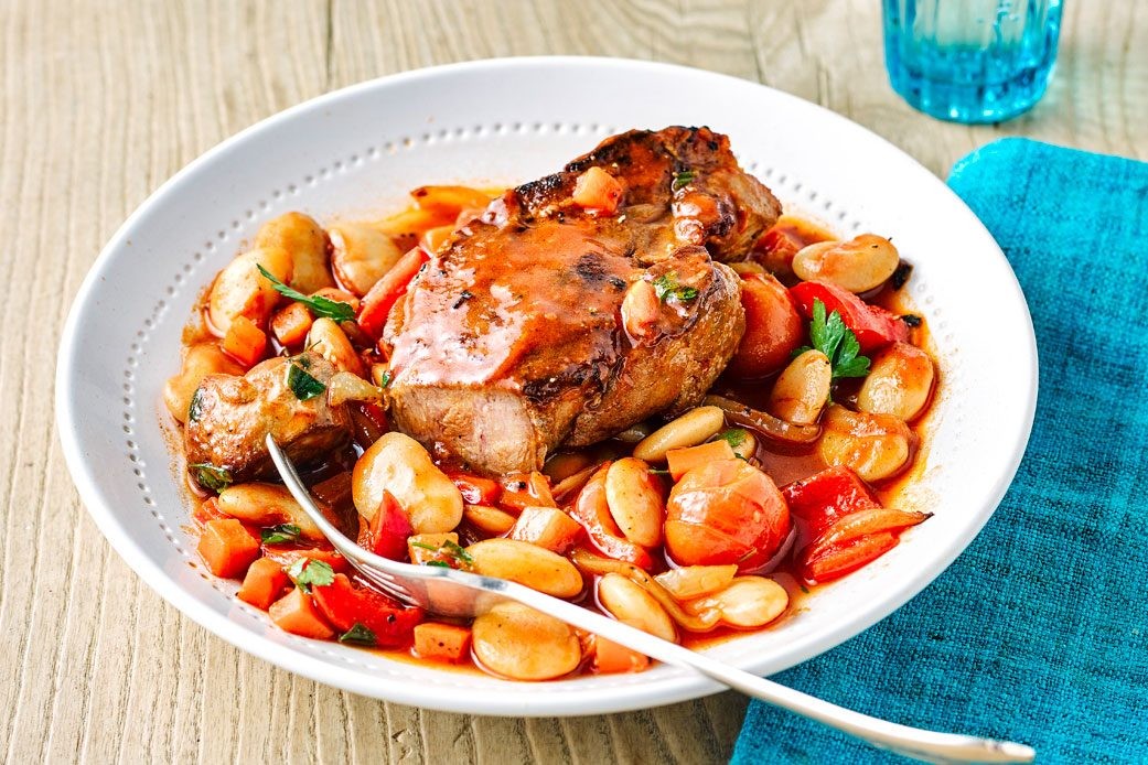 Plate of pork on top of butter beans
