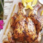 Spatchcock peri peri chicken on a wooden board