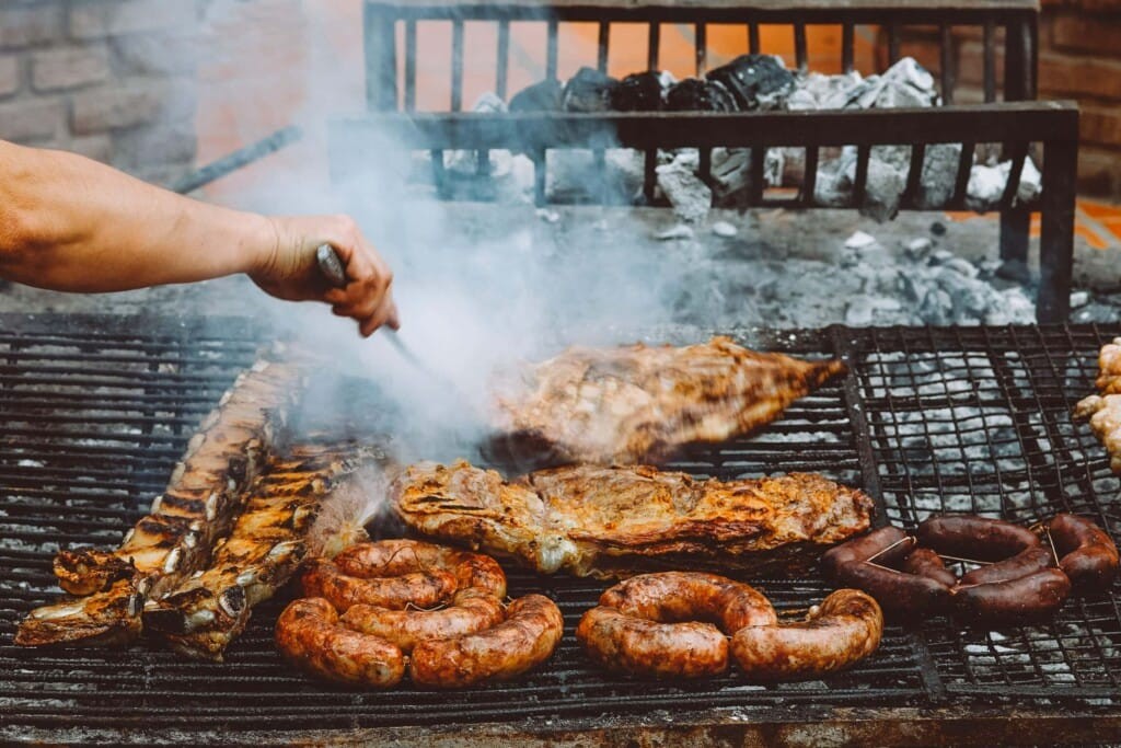 Argentinian asado with various cuts of meat grilling