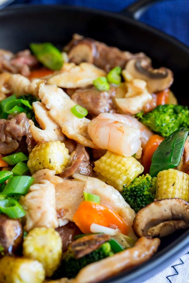 Close-up of chicken and corn in a takeout-style stir-fry, showcasing the savory sauce.