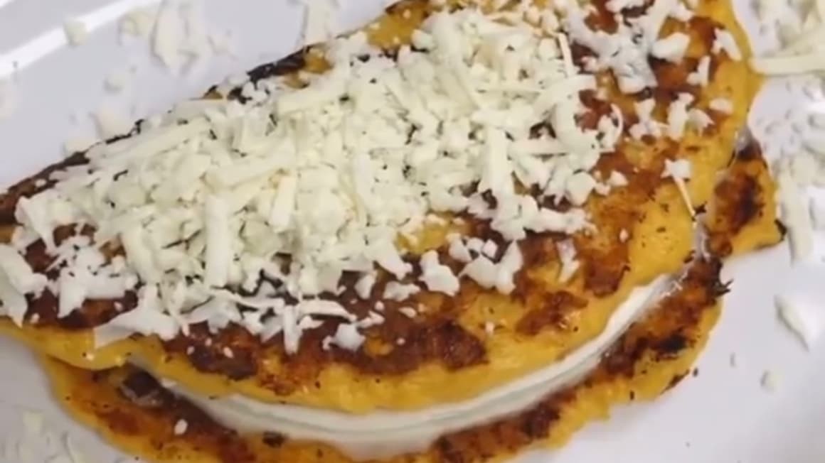 Cachapas on display at a restaurant, highlighting their golden-brown surface and melted cheese filling