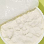 Close-up of fresh cottage cheese, showcasing its texture and creamy appearance