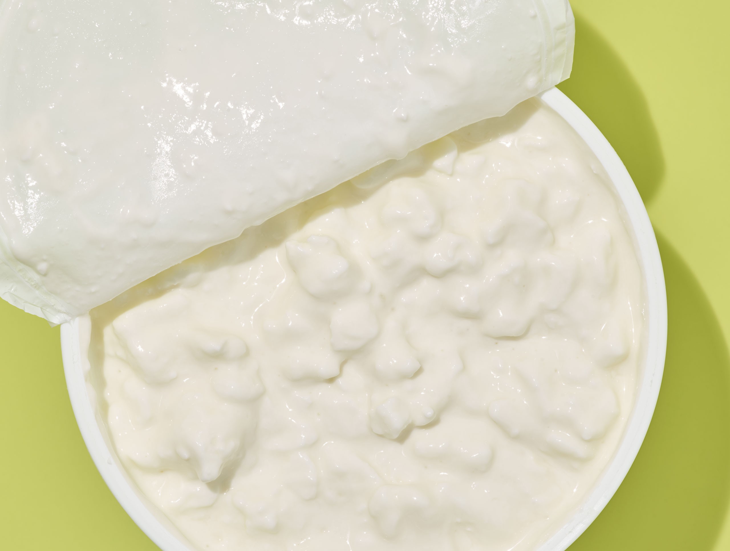 Close-up of fresh cottage cheese, showcasing its texture and creamy appearance