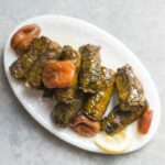 Beef Dolmas with Apricots and Tamarind: Savory grape leaves stuffed with beef, apricots, and tamarind, a sweet and sour delight from the Syrian Jewish kitchen.