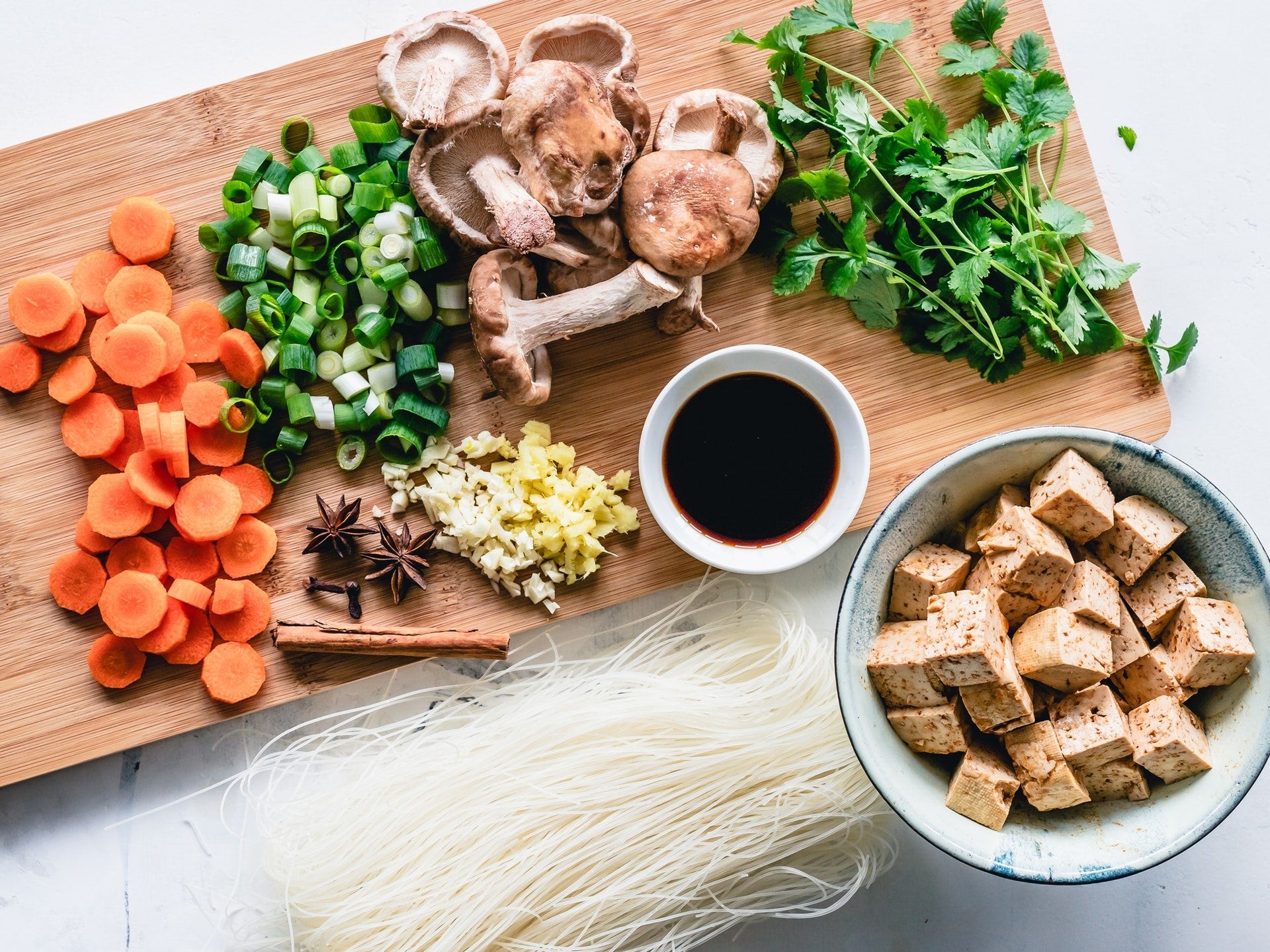 Chopped mushrooms carrots ginger garlic tofu and greens