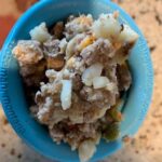 Dog enjoying a West Paw Toppl filled with food