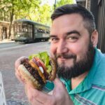 Vegan cheeseburger being held