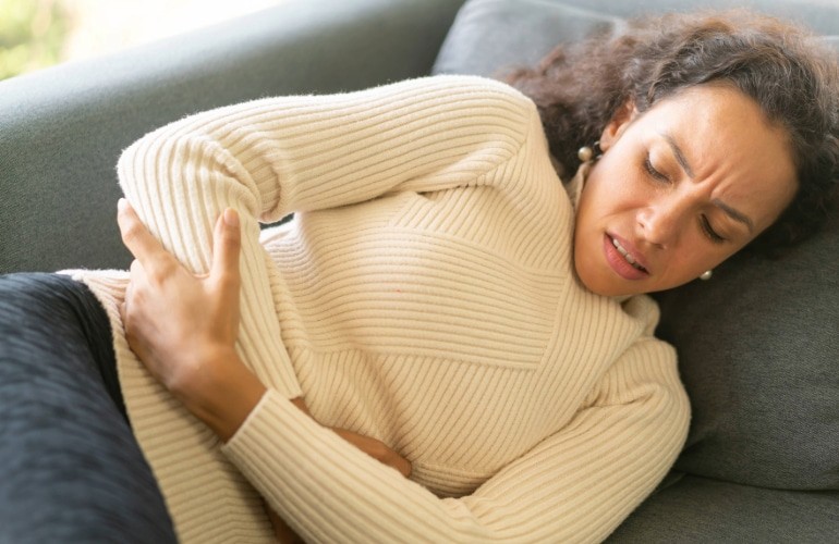 Woman experiencing nausea from food poisoning
