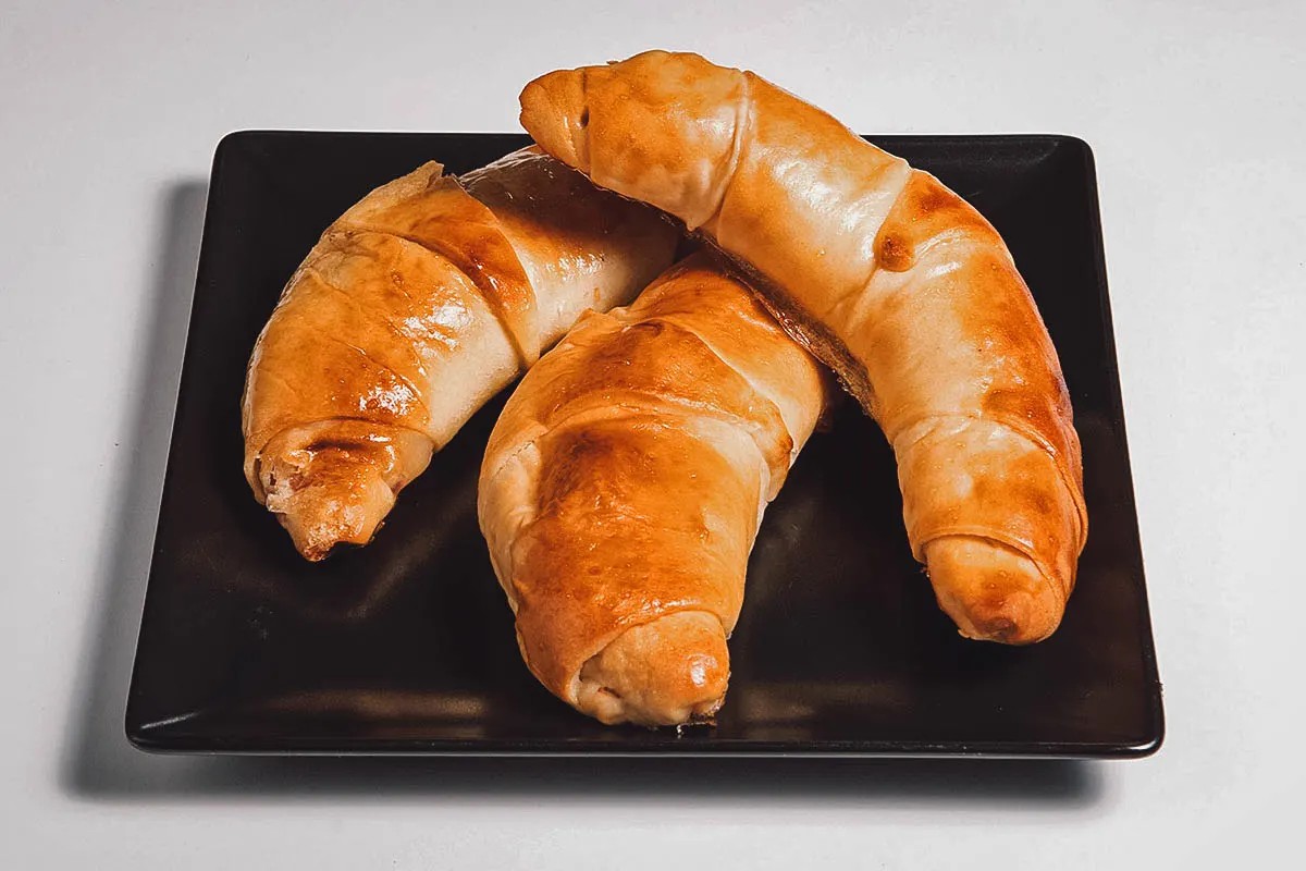 A display of cachitos, showcasing their crescent shape and golden-brown crust