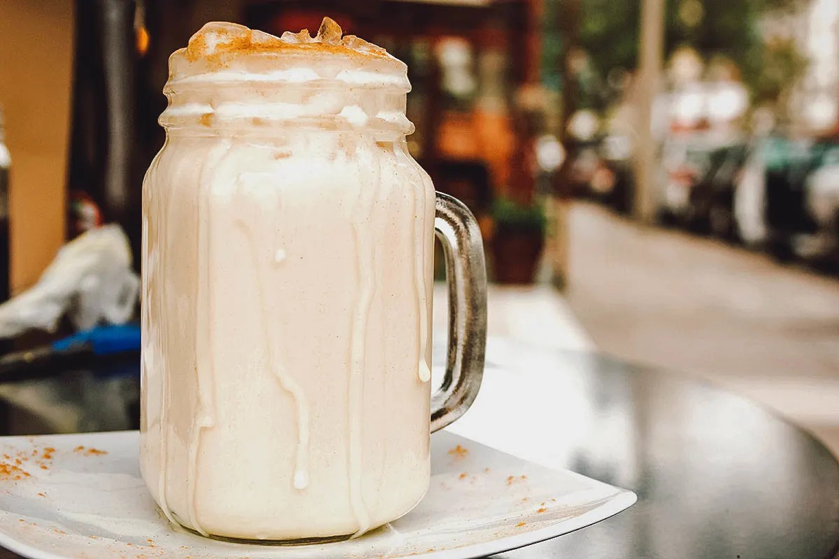 A glass of Chicha, showcasing its creamy texture and sweet flavor