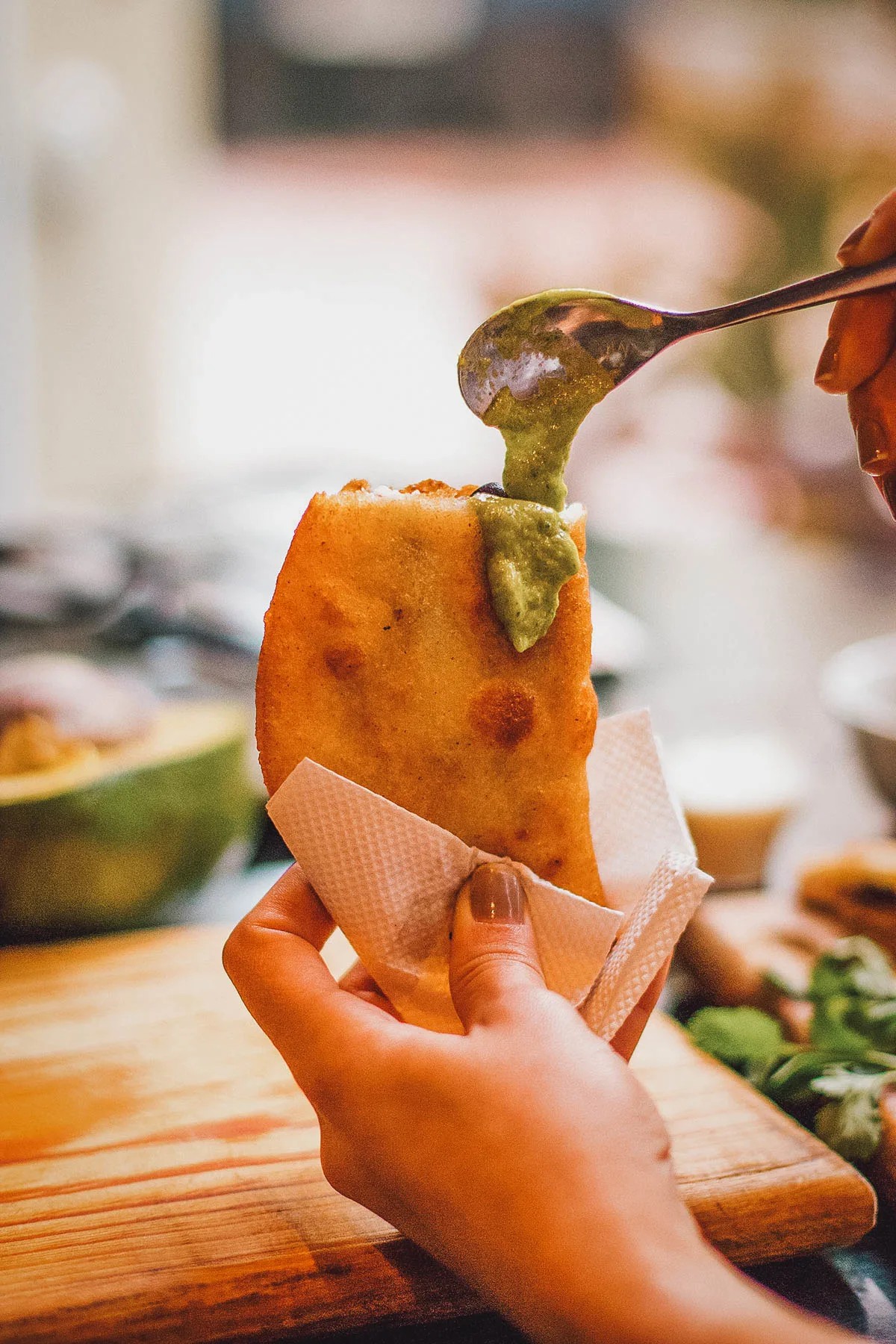 A golden-brown empanada, filled with savory ingredients