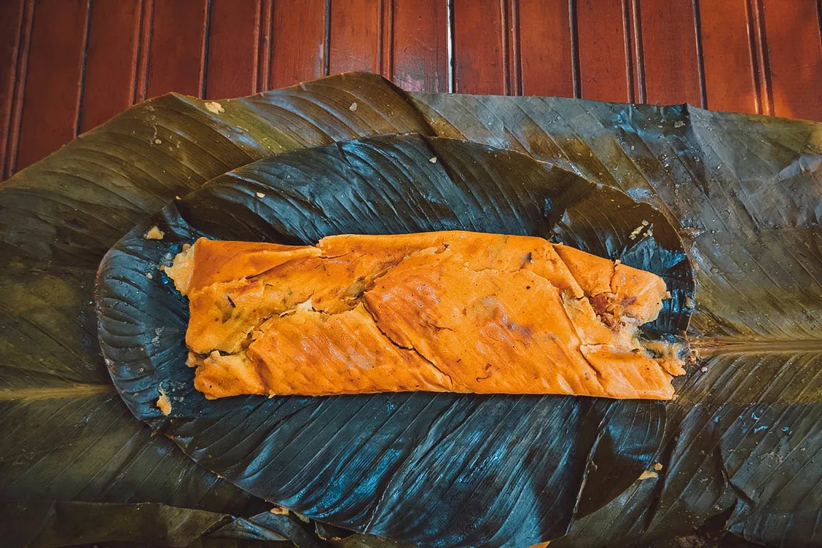 A hallaca wrapped in plantain leaves, ready to be cooked
