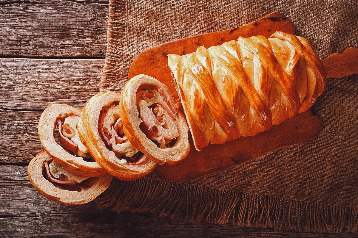 A sliced Pan de Jamon, revealing its colorful filling of ham, olives, and raisins