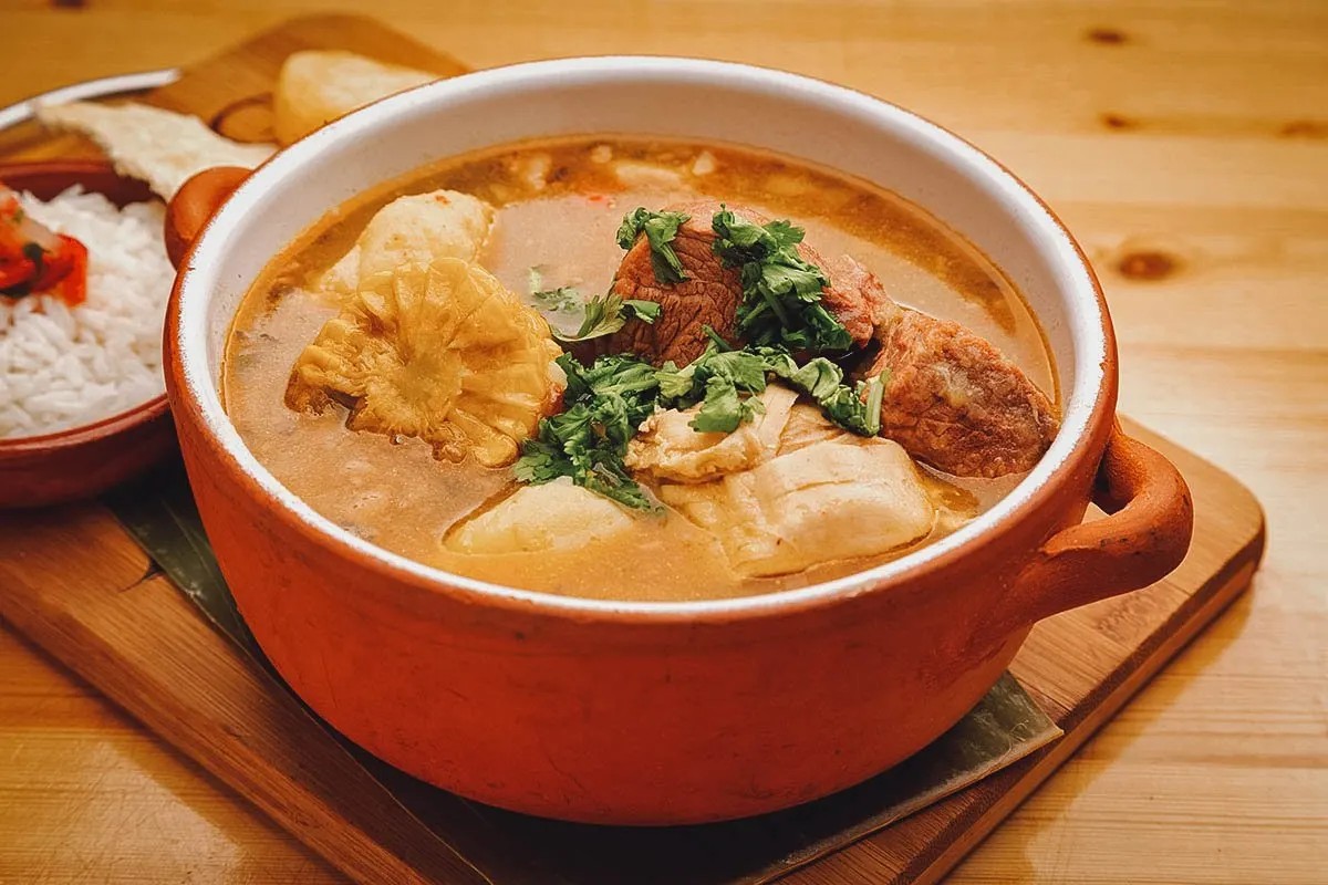 A bowl of Sancocho, showcasing its rich broth and variety of meats and vegetables