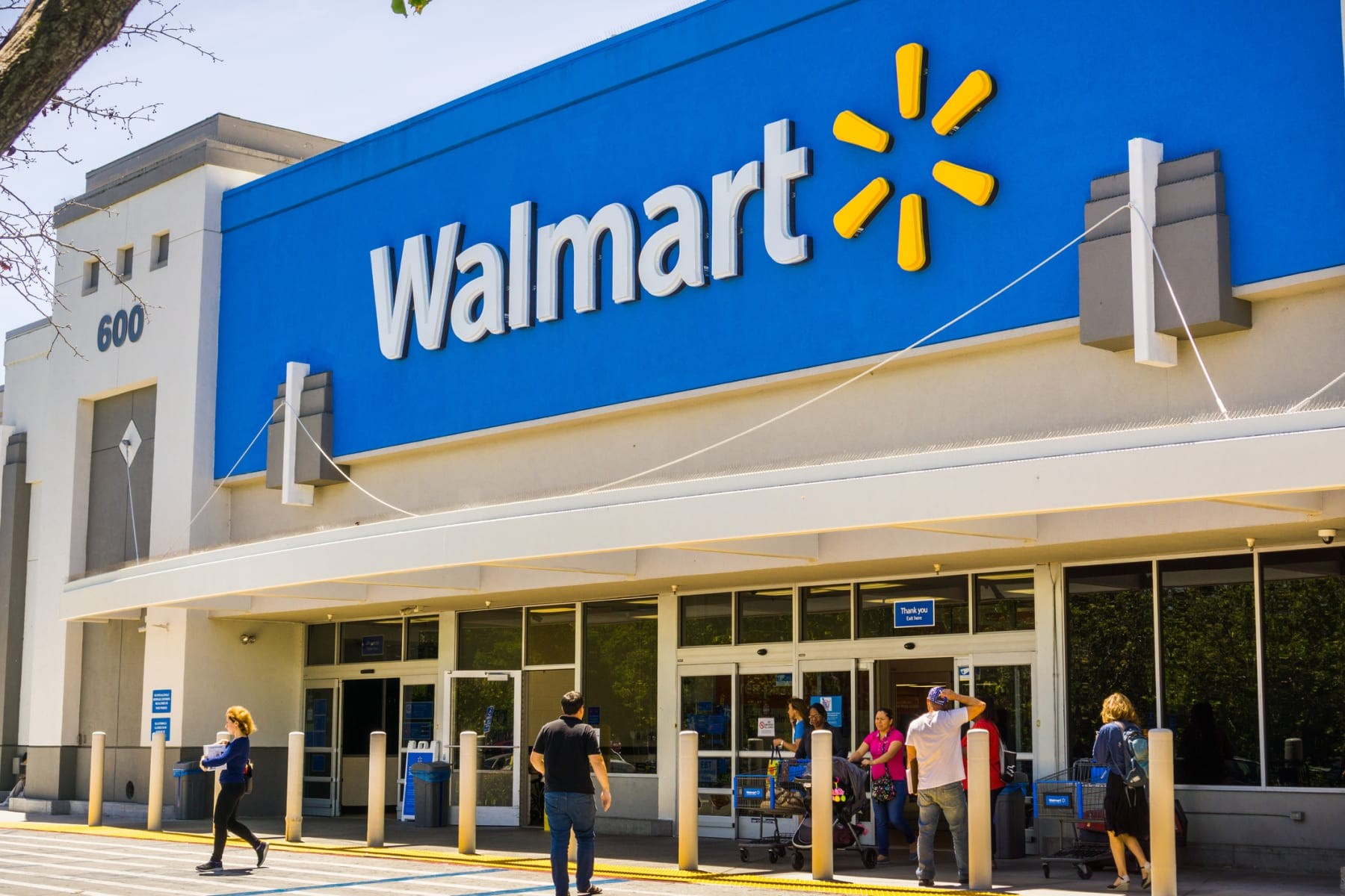 Shoppers walk in an out of Walmart store.