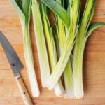 Halved leeks on a cutting board