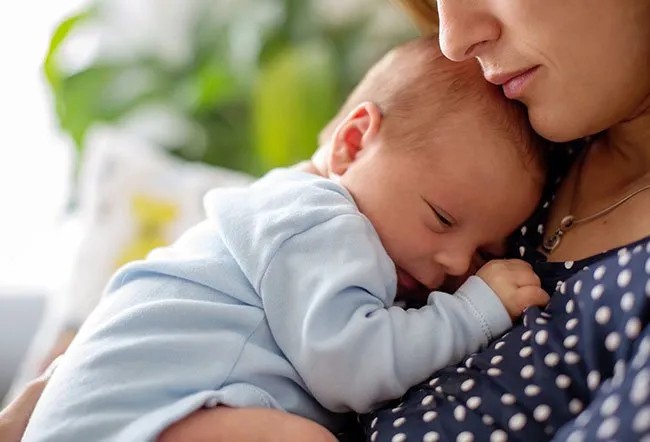 Mother enjoying spicy food while breastfeeding baby
