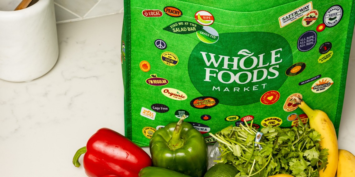 Whole Foods grocery bag filled with healthy foods and potentially alcohol