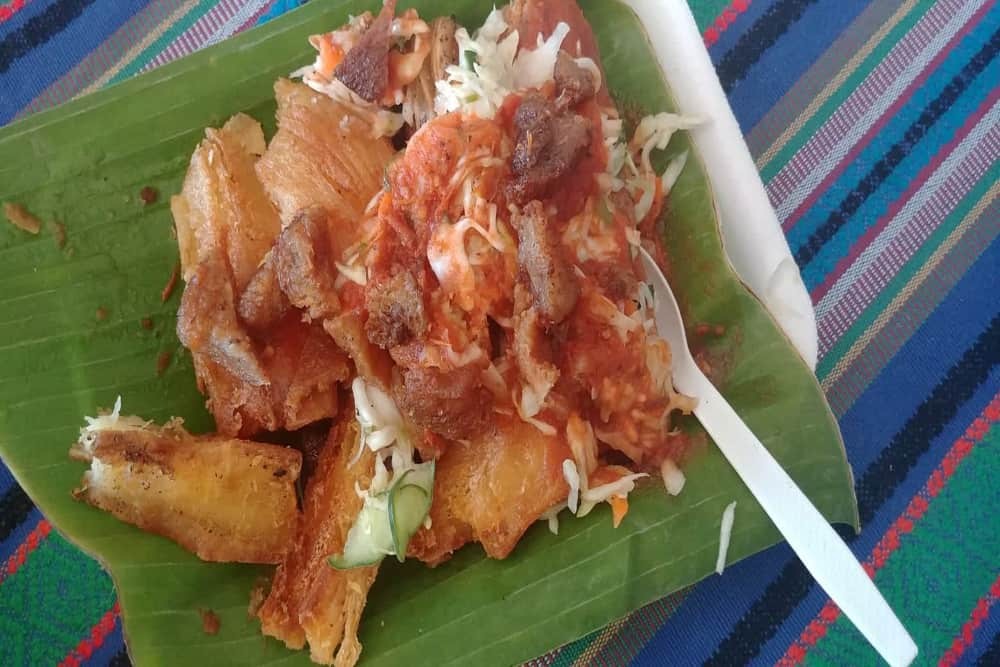Fried yuca with stewed meat and salsa